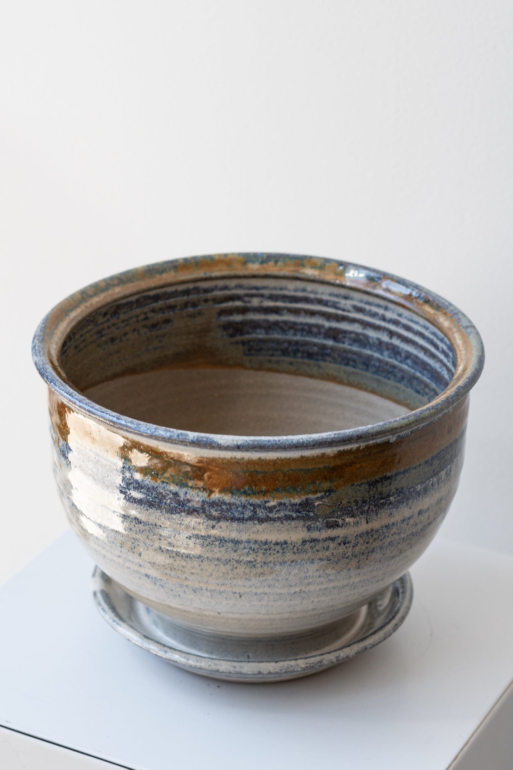 Bruning Pottery Planter ivory & iron glaze - 6" on white surface in a white room ©Sprout Home