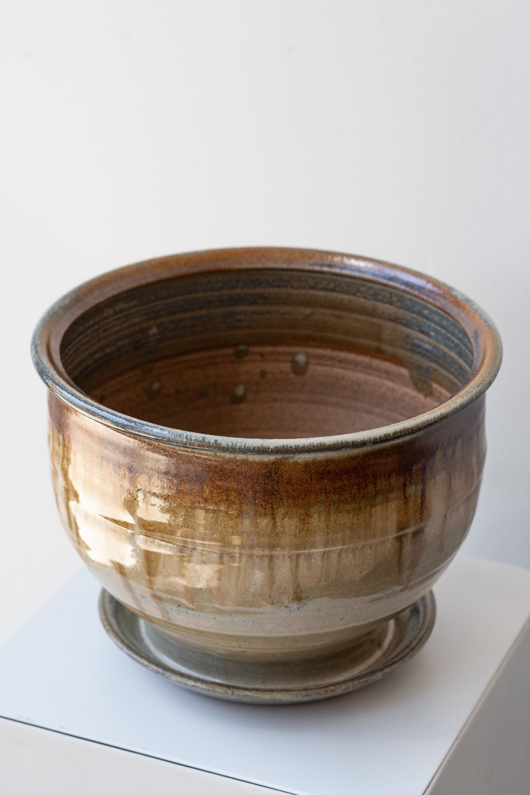Bruning Pottery Planter ivory & iron glaze - 8" on white surface in a white room ©Sprout Home