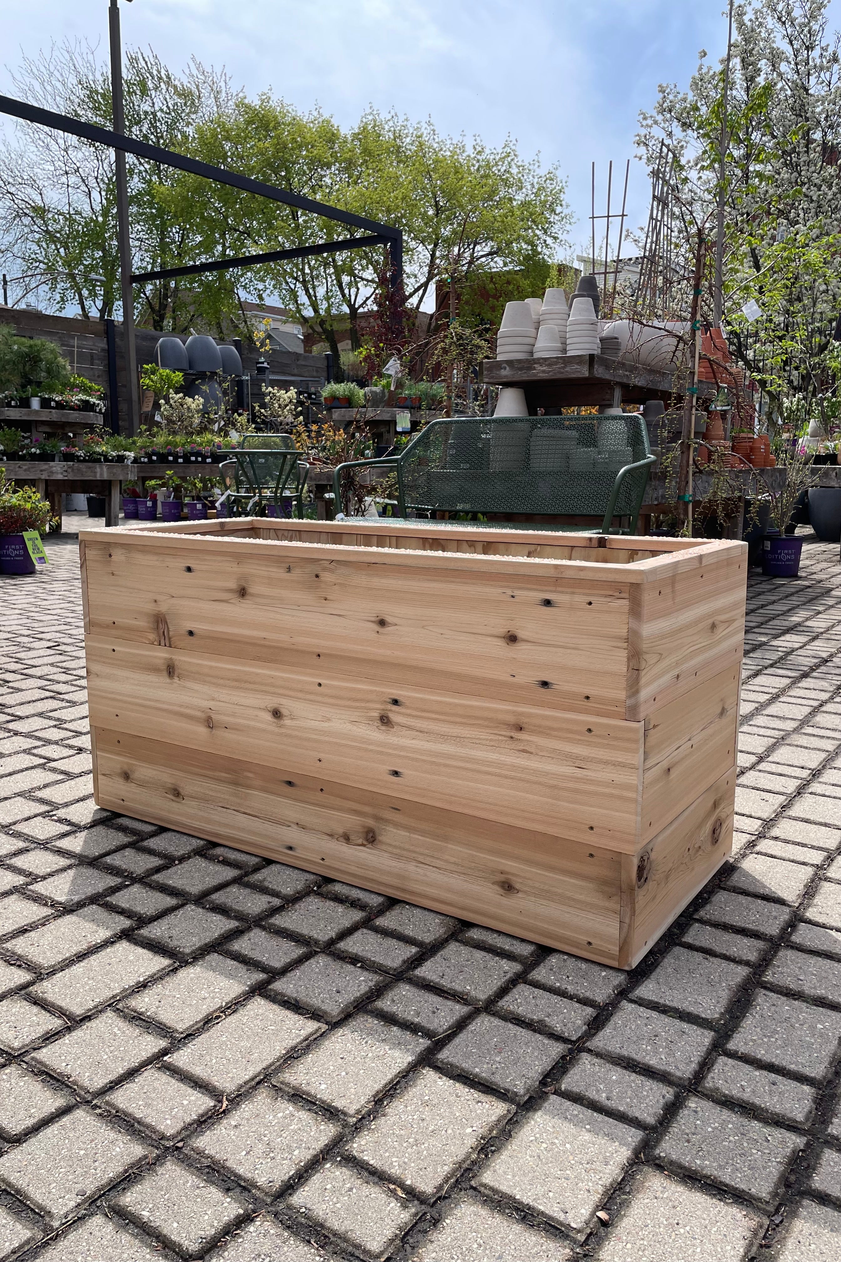 The handmade cedar rectangular planter box shown empty at Sprout Home.