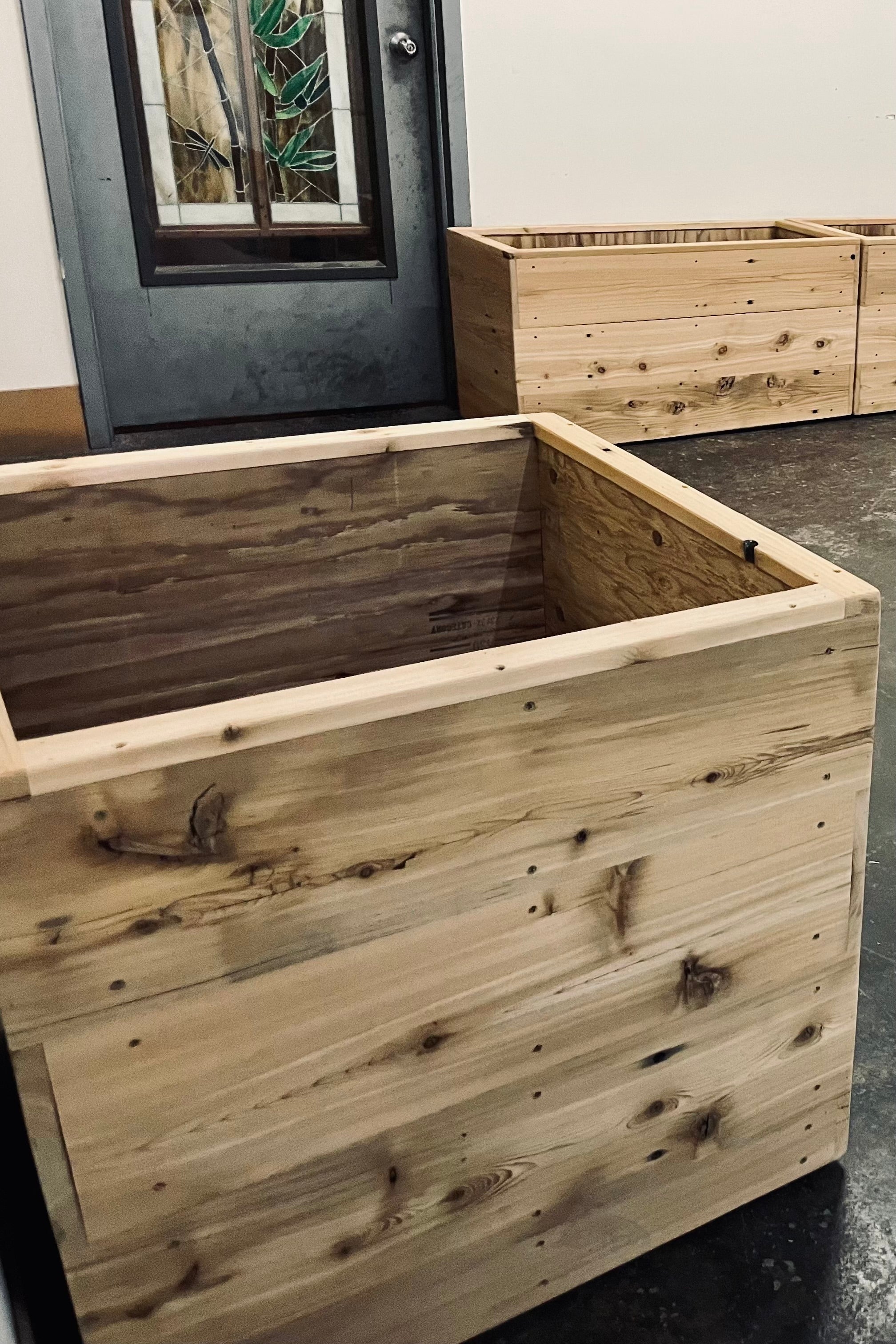 Square 26" cedar handmade planter in the designers studio.