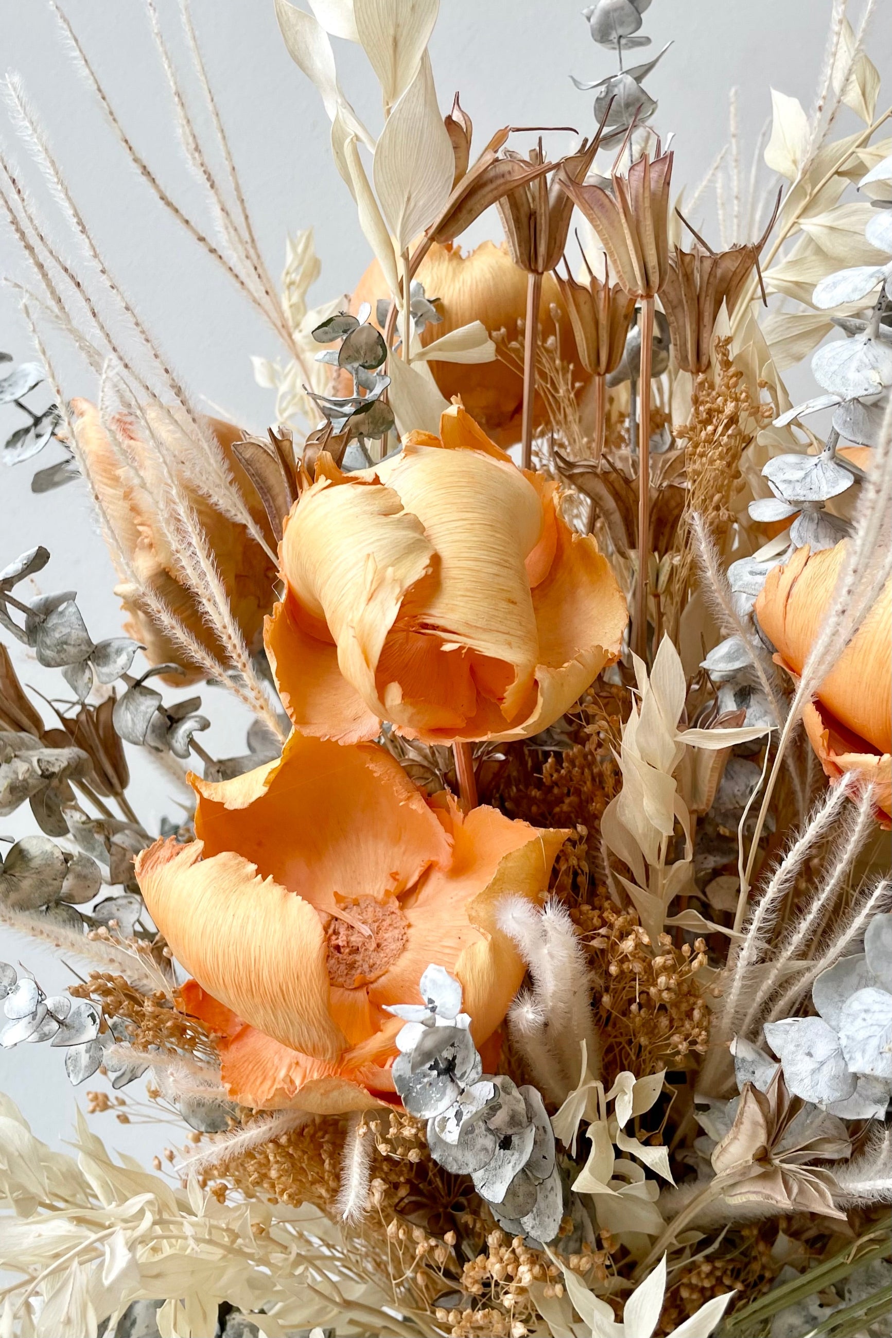A close-up view of the $160 option of Preserved Arrangement Creamsicle by Sprout Home against a white backdrop ©Sprout Home #size_$160