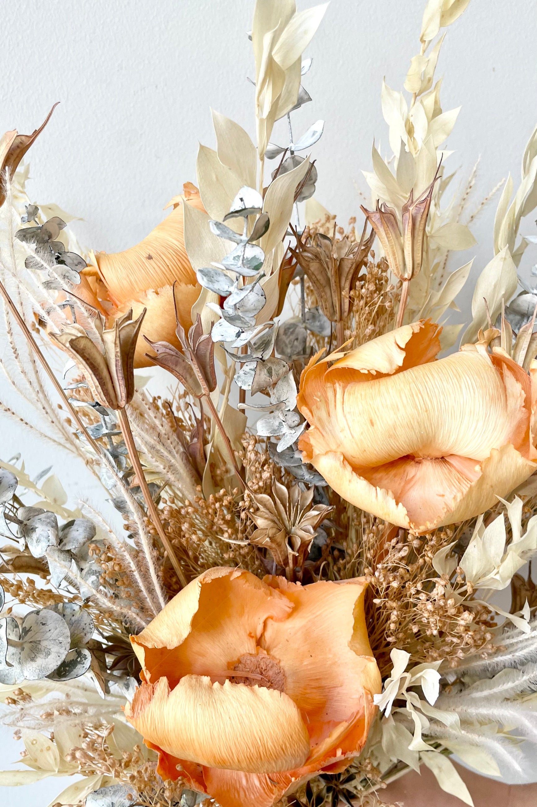 A close-up view of the $85 option of the $60 version of Preserved Arrangement Creamsicle by Sprout Home against a white backdrop ©Sprout Home #size_$85