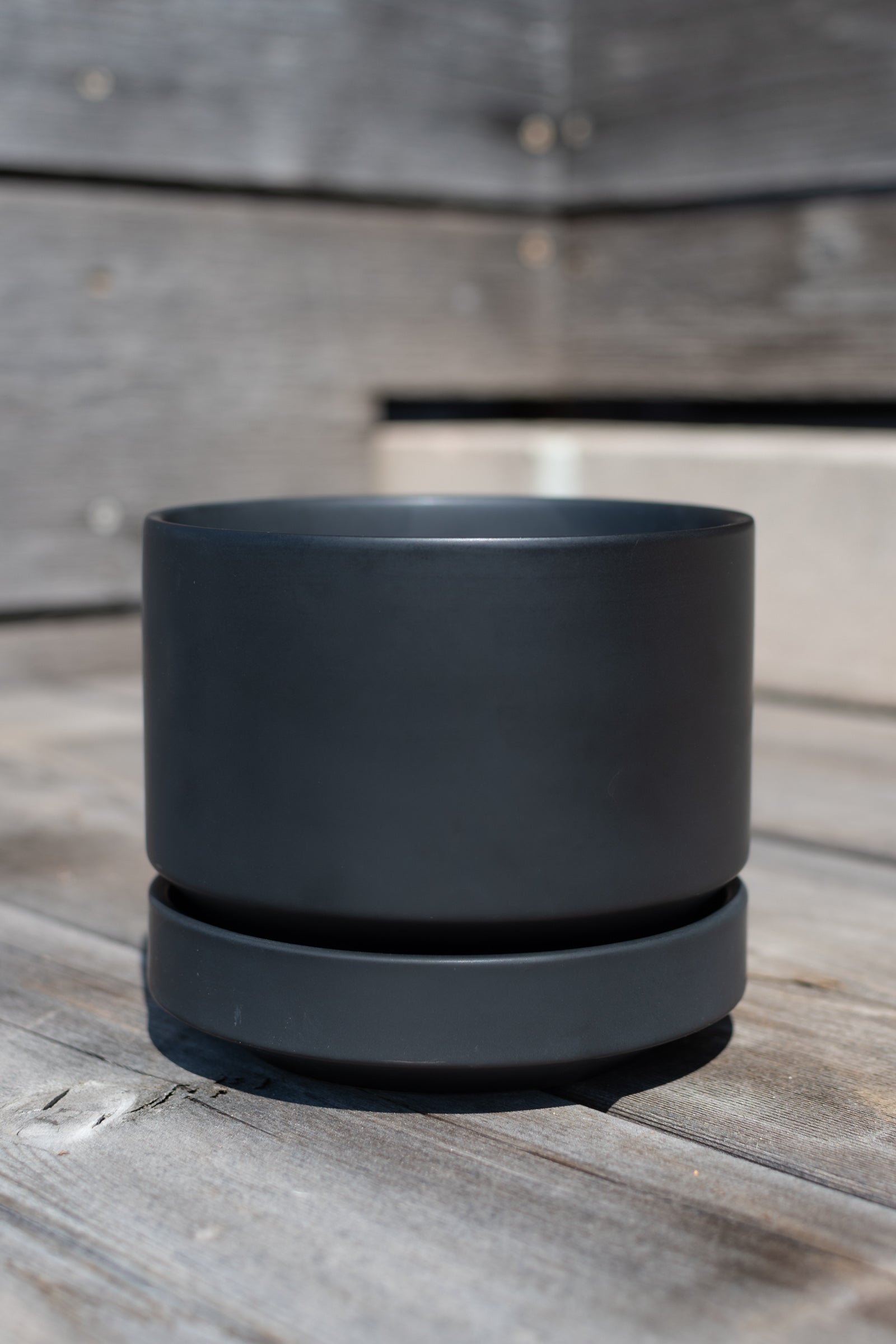 Round Pot & Saucer black 4" by LBE Designs in front of grey wood background