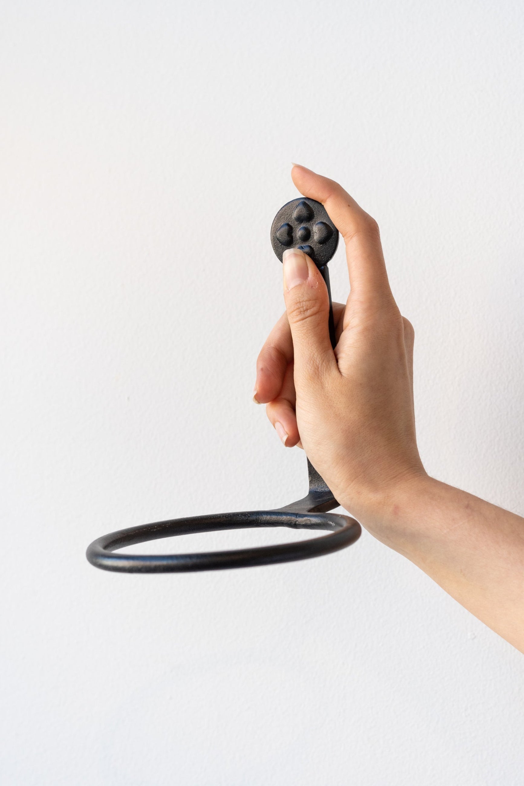 Flower pot rind being held in hand, empty, against a white backdrop ©Sprout Home