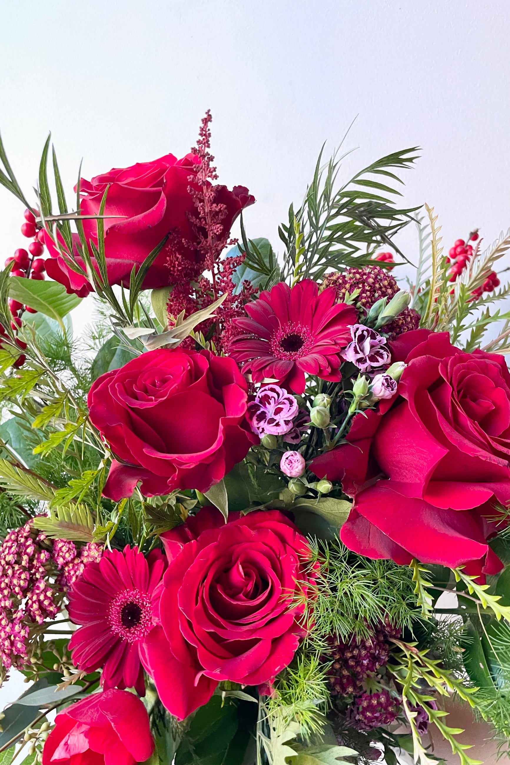A detail view of an example of fresh Floral Arrangement Solstice with red roses and gerbers from Sprout Home Floral in Chicago ©Sprout Home #size_$160