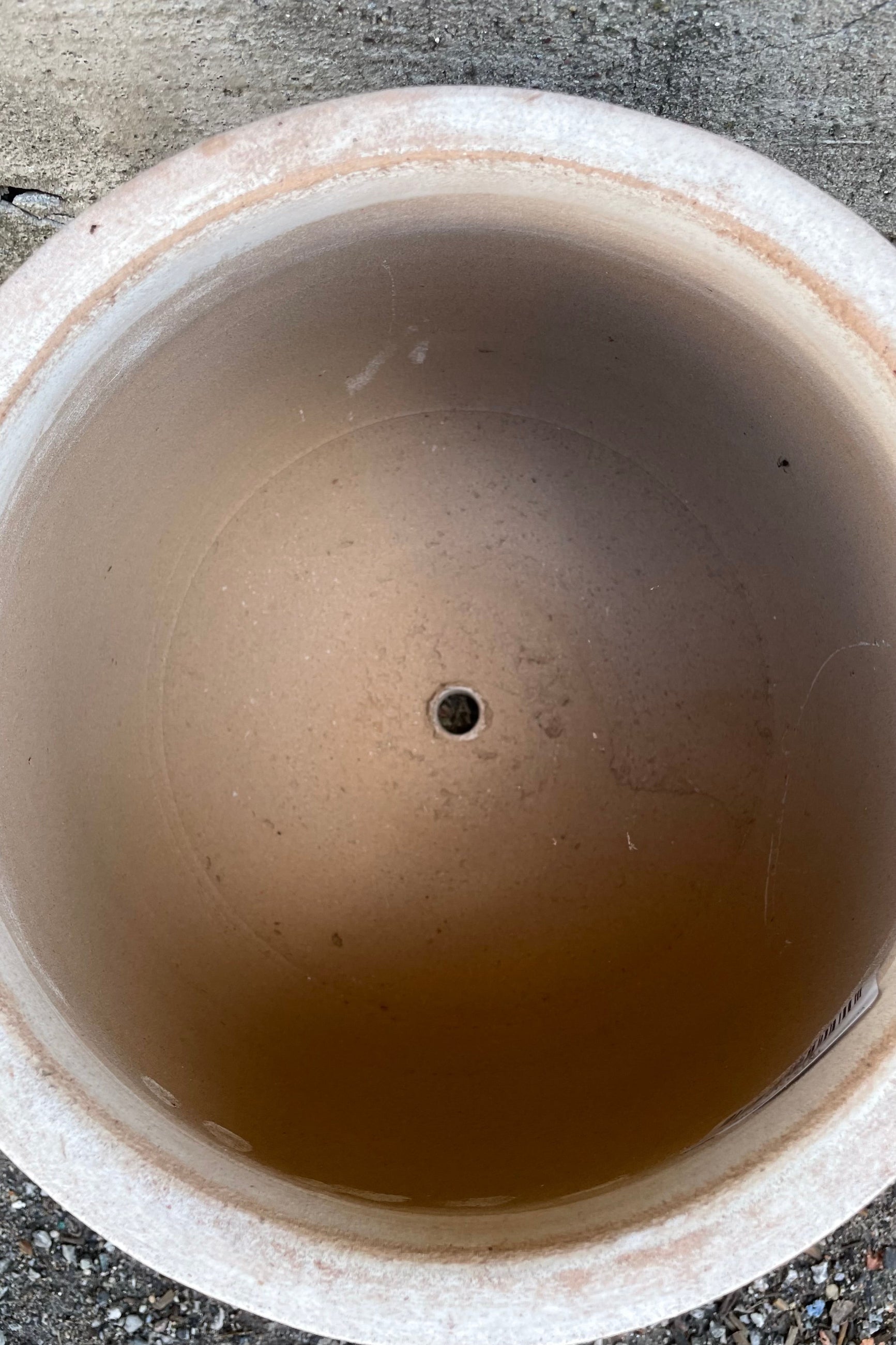 Detail of the inside of the Yumiko Unglazed Planter Small against a grey wall ©Sprout Home