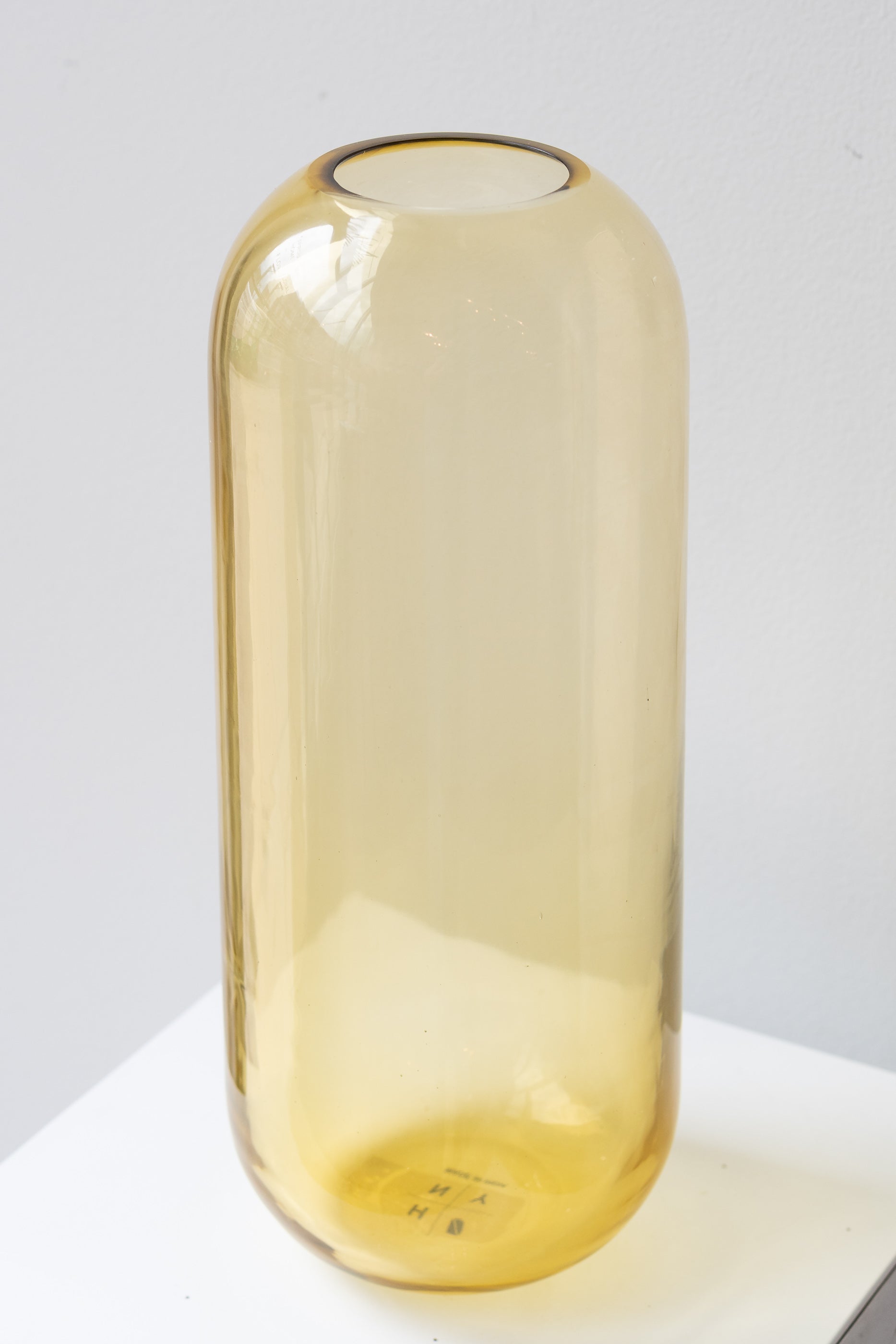 Hawkins New York large amber Aurora pill vase in front of white background