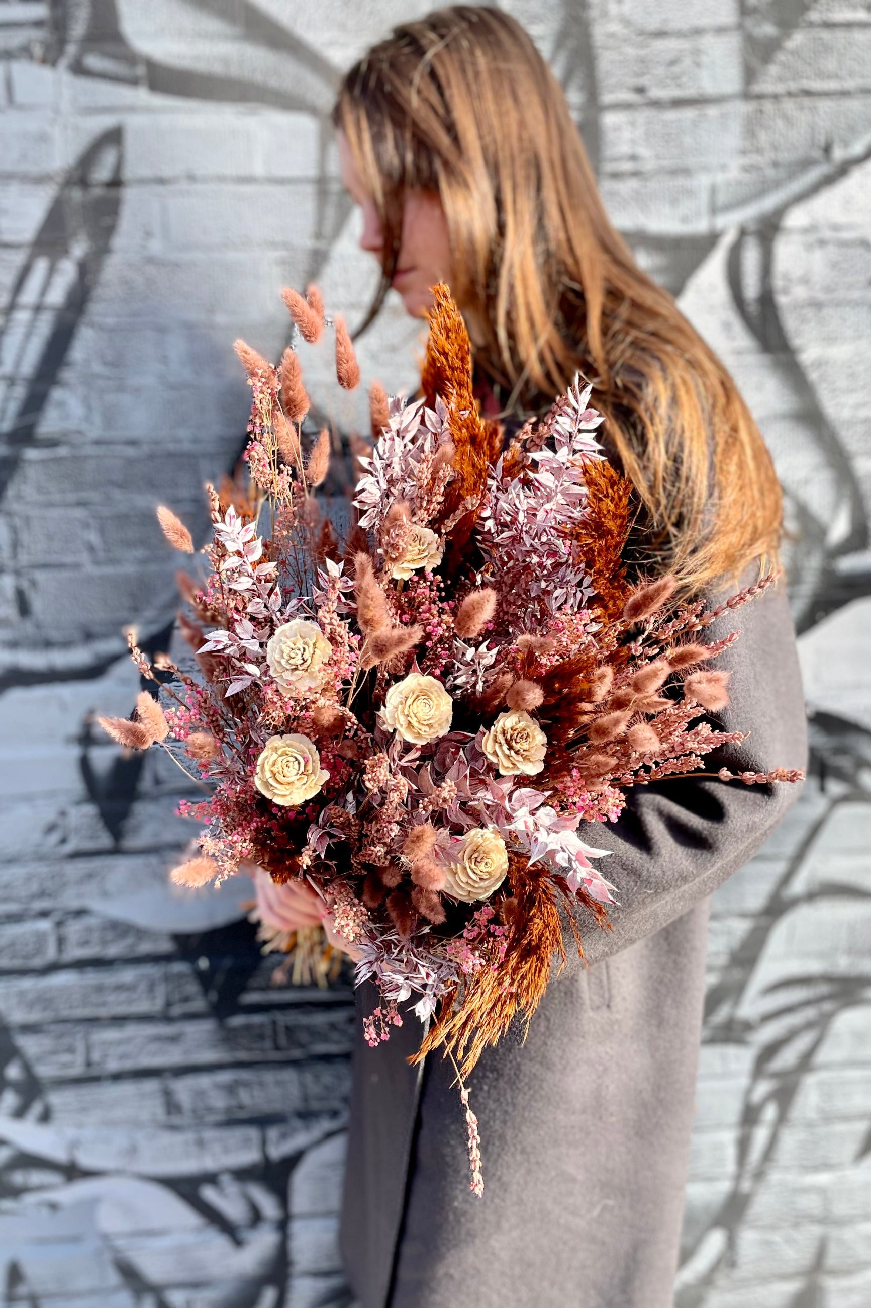 JJ, one of the Sprout Home florists holding the Ambrosia preserved arrangement ©Sprout Home #size_$160