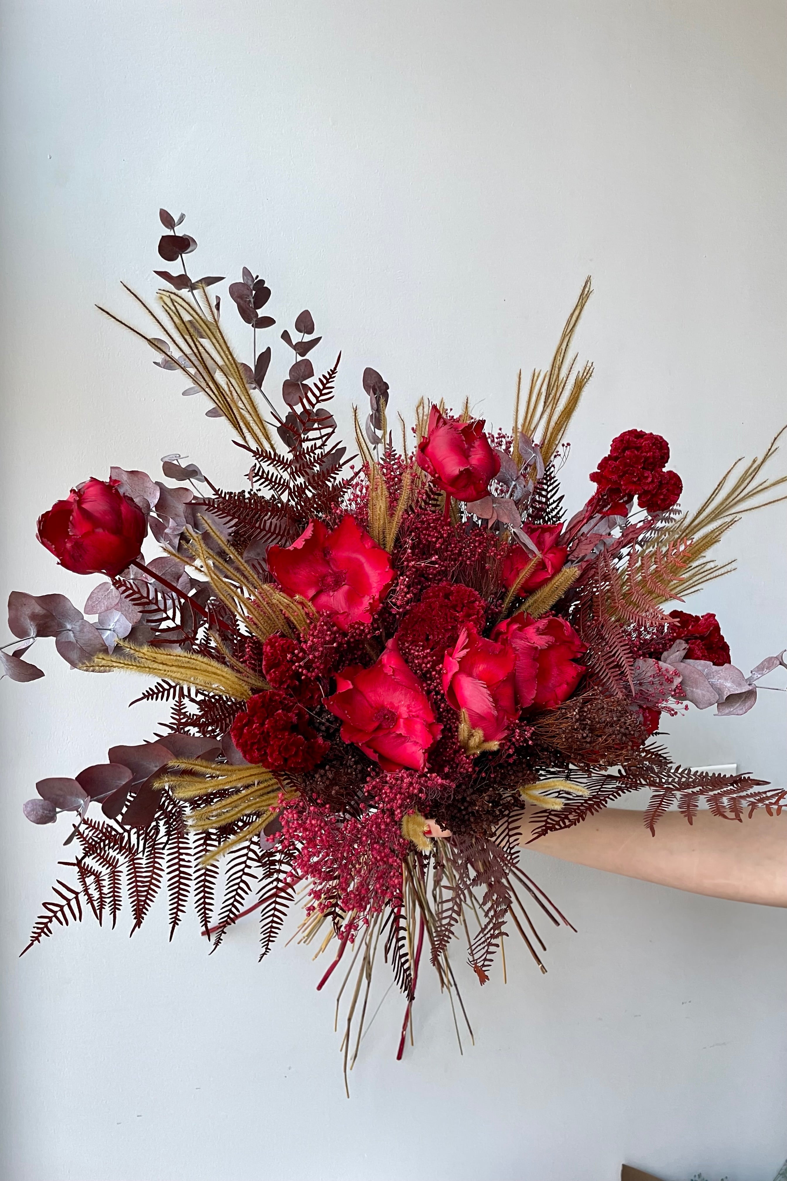 Preserved Red Velvet arrangement against a white wall #size_$200