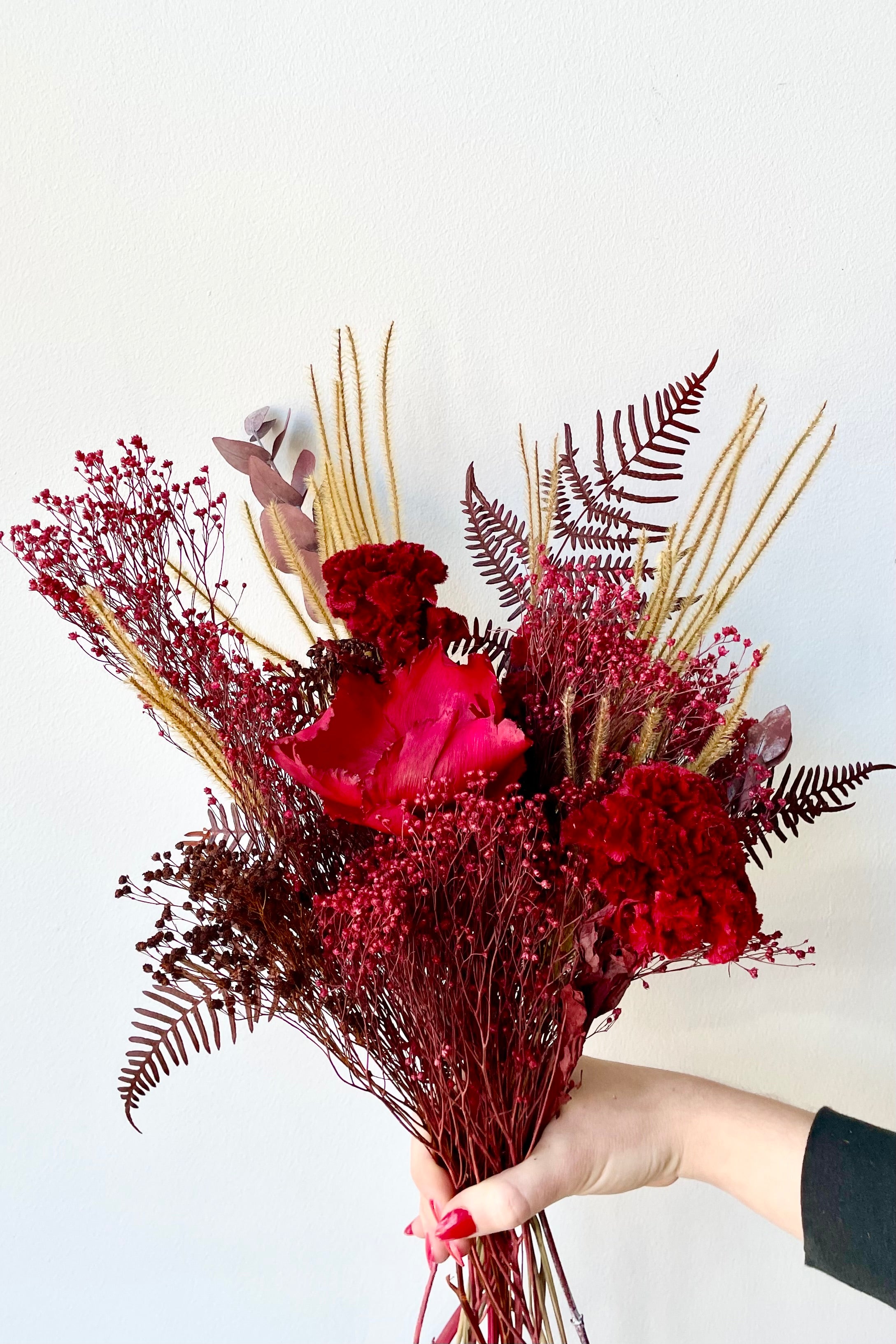 Preserved Red Velvet arrangement against a white wall #size_$60