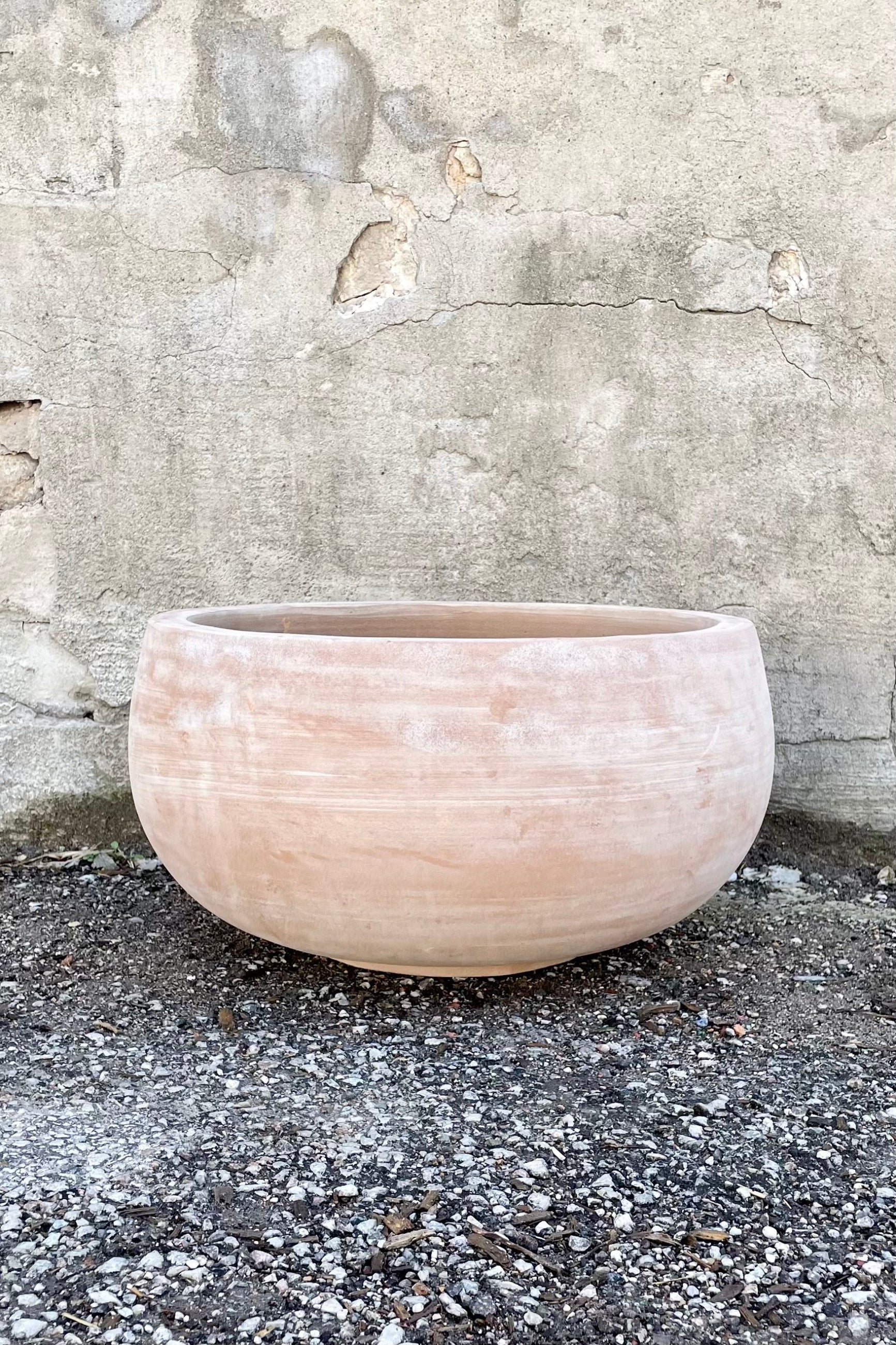 Yumiko Unglazed Bowl Large against a grey wall ©Sprout Home