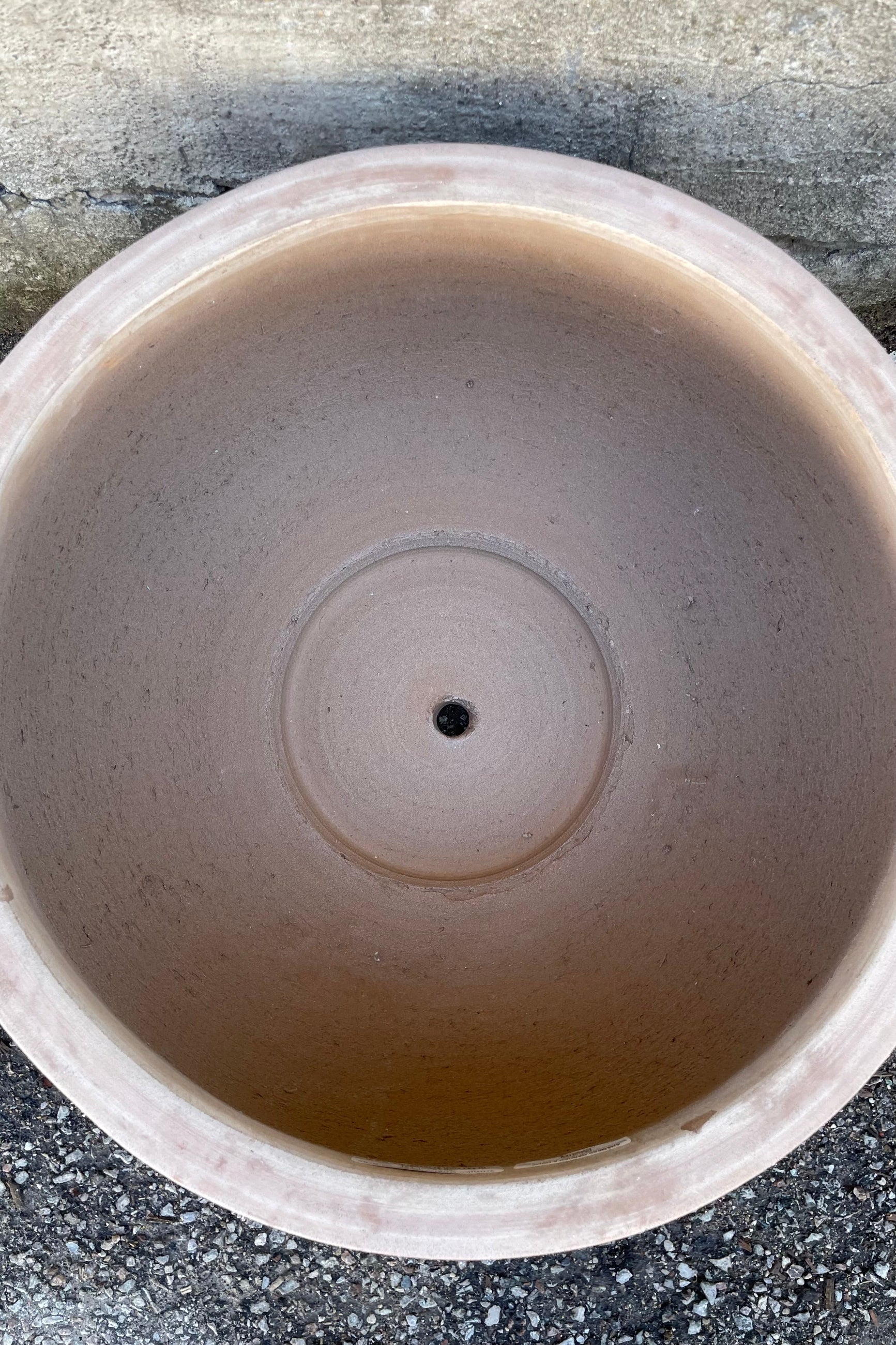 Detail of the inside of the Yumiko Unglazed Bowl Large against a grey wall ©Sprout Home