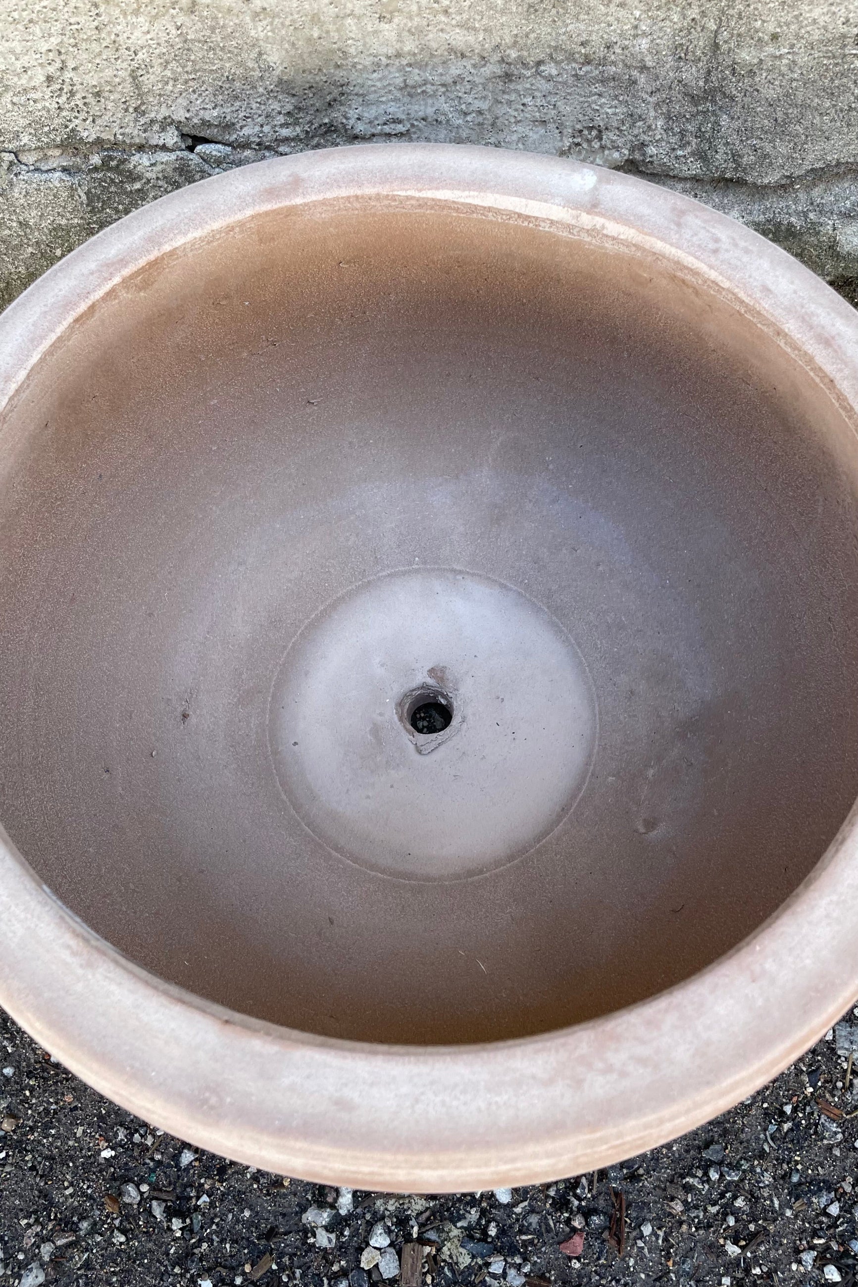 detail of the inside of the Yumiko Unglazed Bowl Small against a grey wall ©Sprout Home