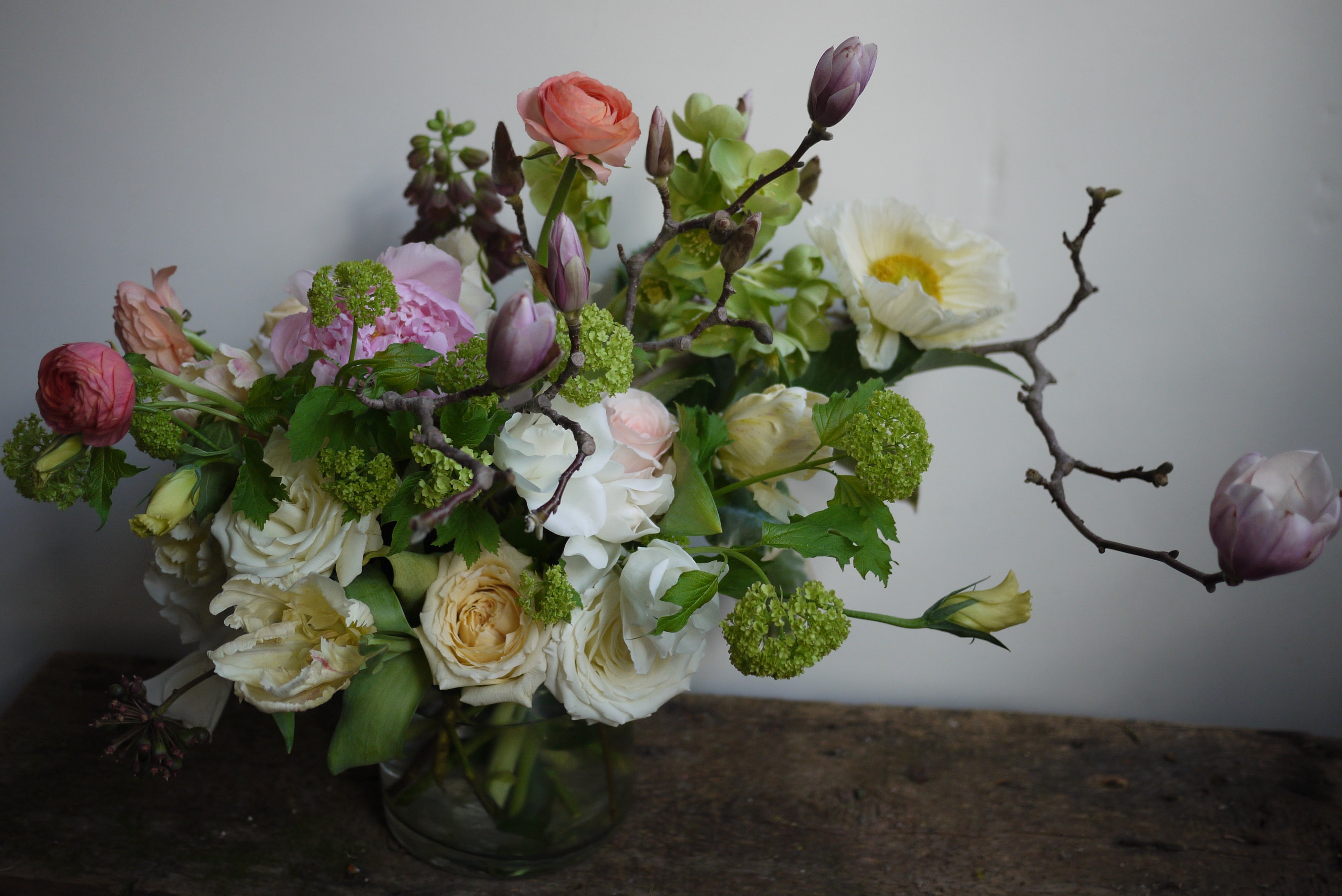 Fresh floral arrangement by Sprout Home with flowering branches.