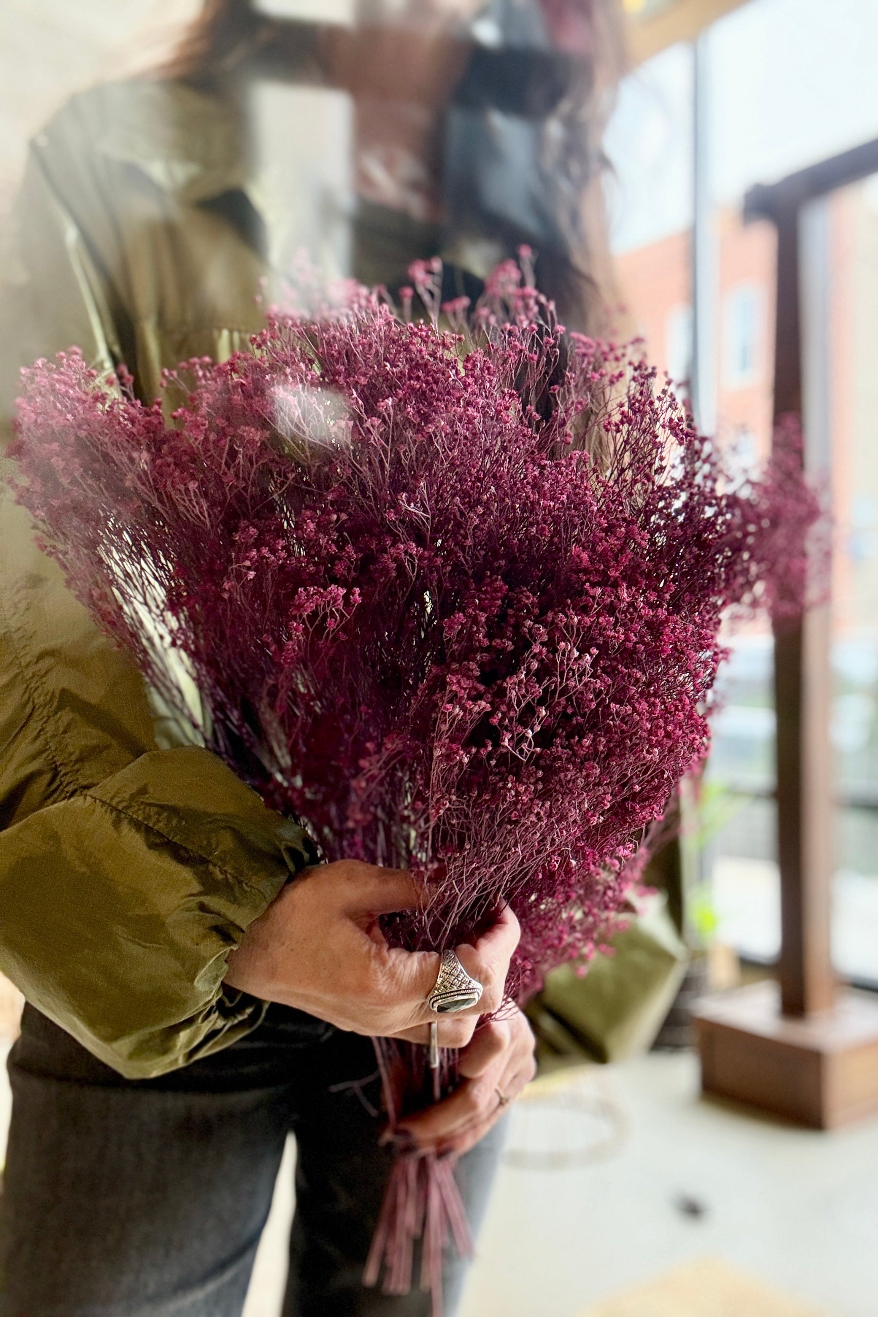 Person holding a Brooms Dusty Antique Rose Color Preserved Bunch indoors ©Sprout Home