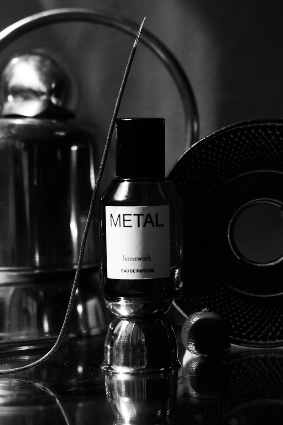 Metal Eau de Parfum Perfume bottle labeled 'Metal' with a metallic background ©Homework