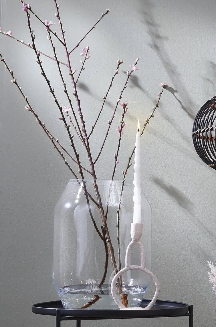 Dali glass vase with branches on to9p of a black side table with a candle and candlestick in front ©Creation Jute USA