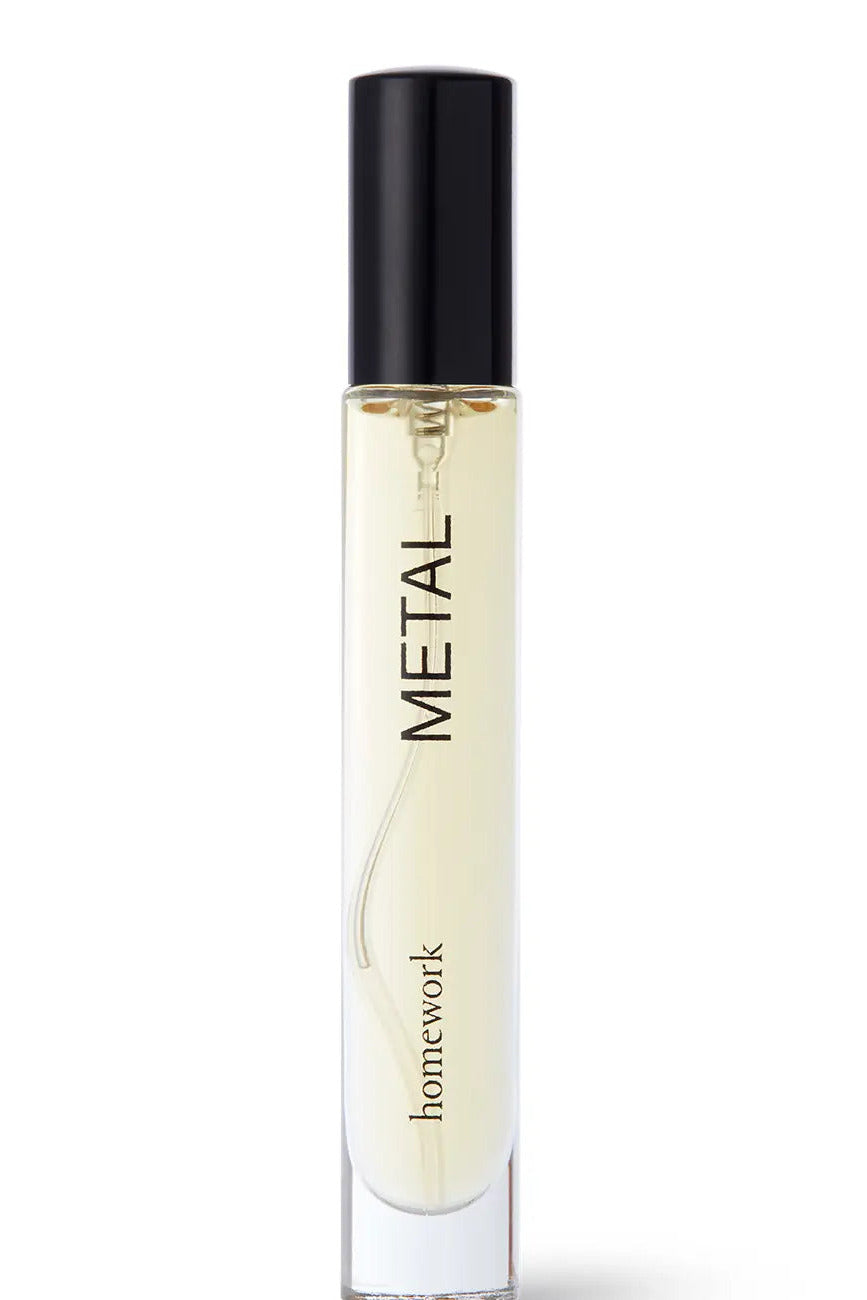 Perfume bottle labeled 'Metal' by 'homework' on a white background ©Homework
