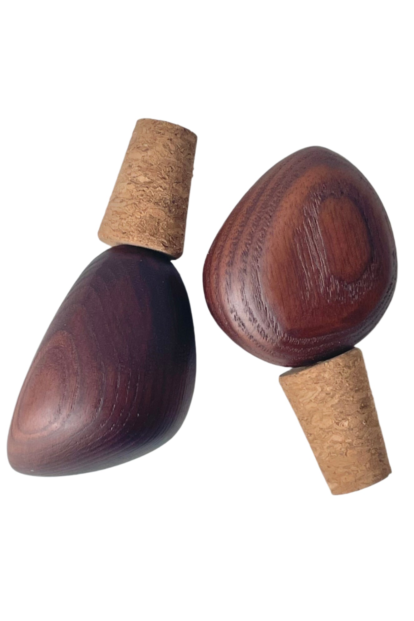 Photo of a pair of wood-topped cork bottle stoppers or wine stoppers.  The warm wood tones and wood grain are visible. Shown on a white background ©Sprout Home