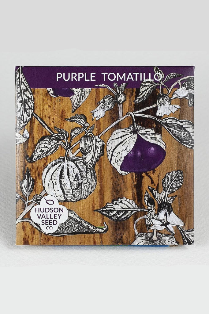 Seeds packet for Purple Tomatillo with Hudson Valley Seed Co. branding on a wooden background ©Hudson Valley Seed Co.