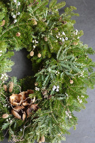 An evergreen wreath on a gray background ©Sprout Home