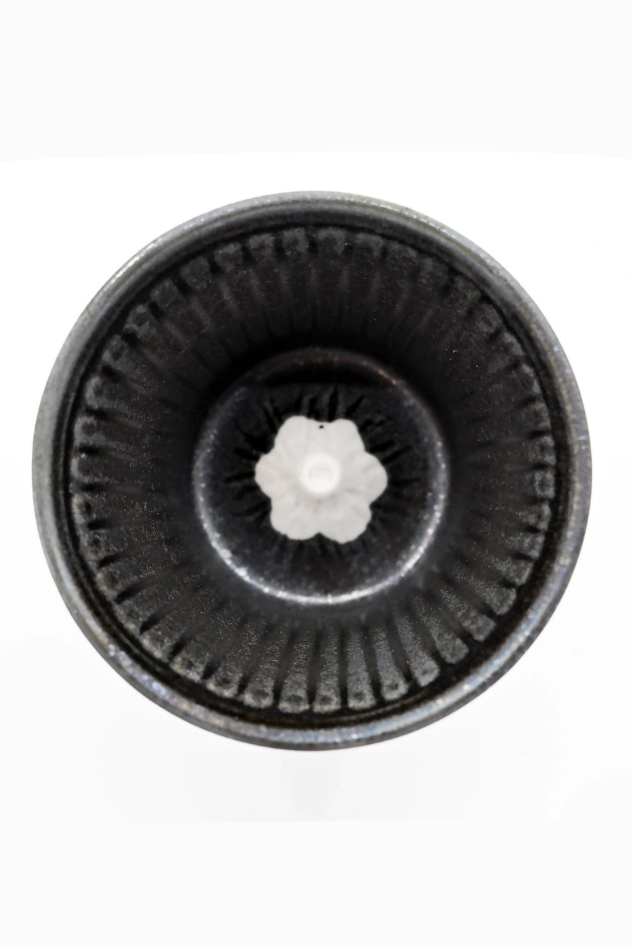 Close-up of a black circular interior of the Fuji Sakura with a central white component on a white background  ©Urban Tokyo
