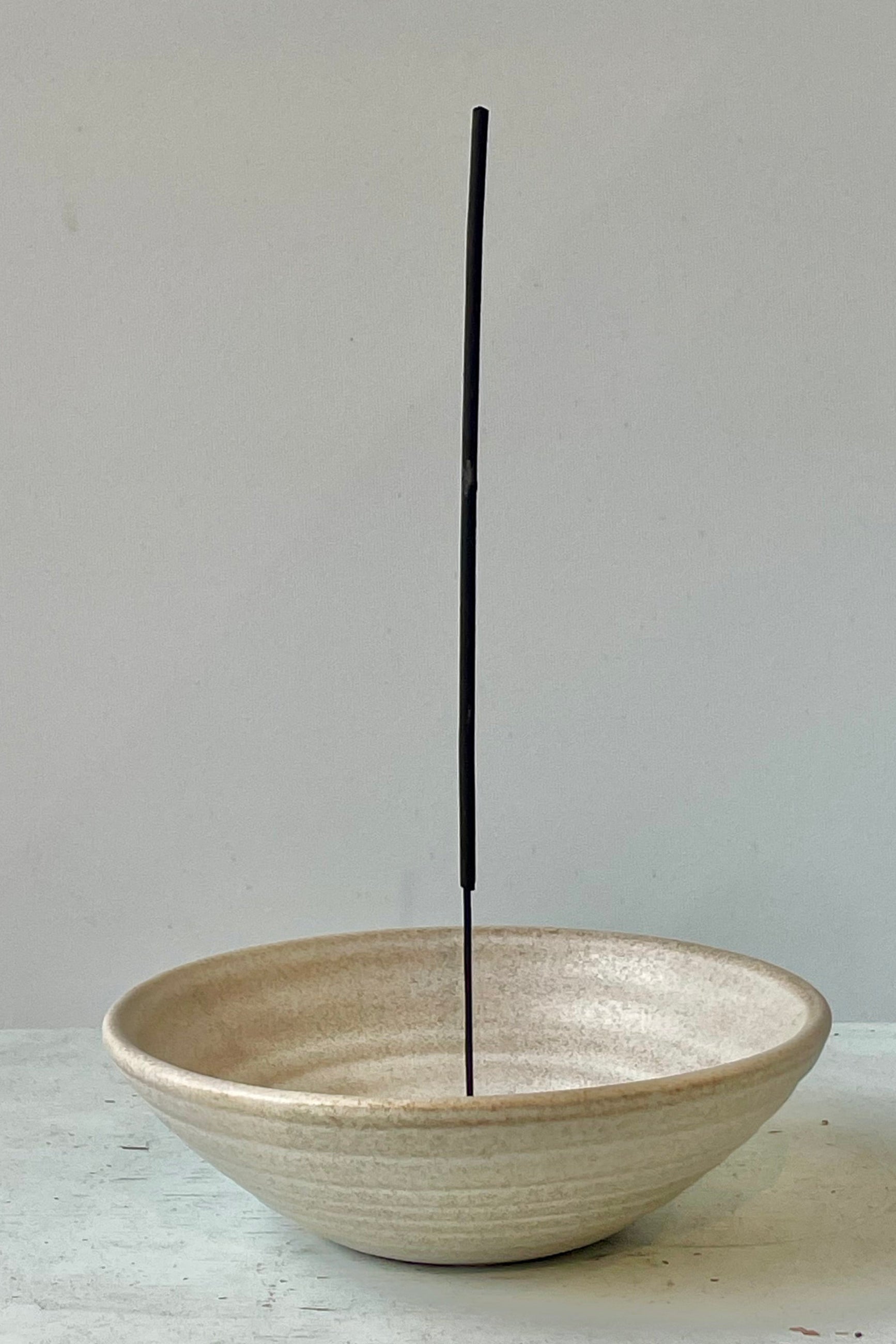 A ceramic incense dish with incense stick in a white room ©Sprout Home