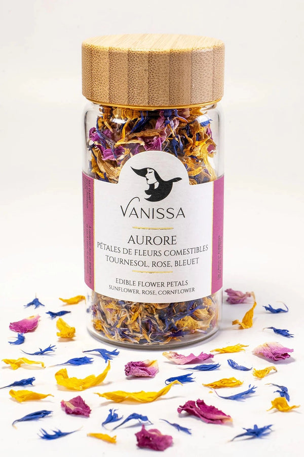 Vanissa Aurore edible flower petals jar with loose petals around the packaging.