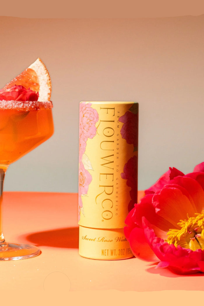 Flowerco finishing sugar with an orange cocktail and red flower on a gradient background  ©Flouwer Co.