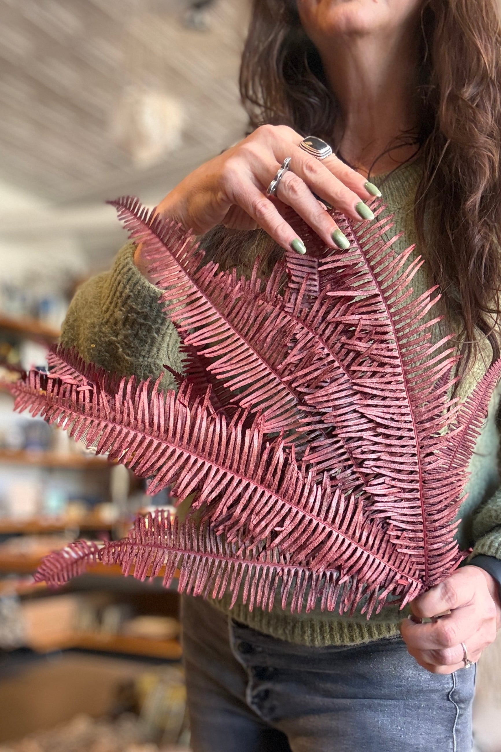 Person holding a Helecho Seagul Burgundy Color Preserved Bunch indoors at Sprout Home Floral ©Sprout Home