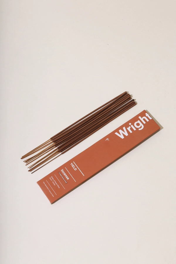 Wright Stick Incense by Yield terracotta colored packaging and the loose sticks next to it.