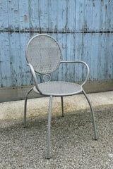 Grey bistro chair at Sprout Home sitting on a concrete floor