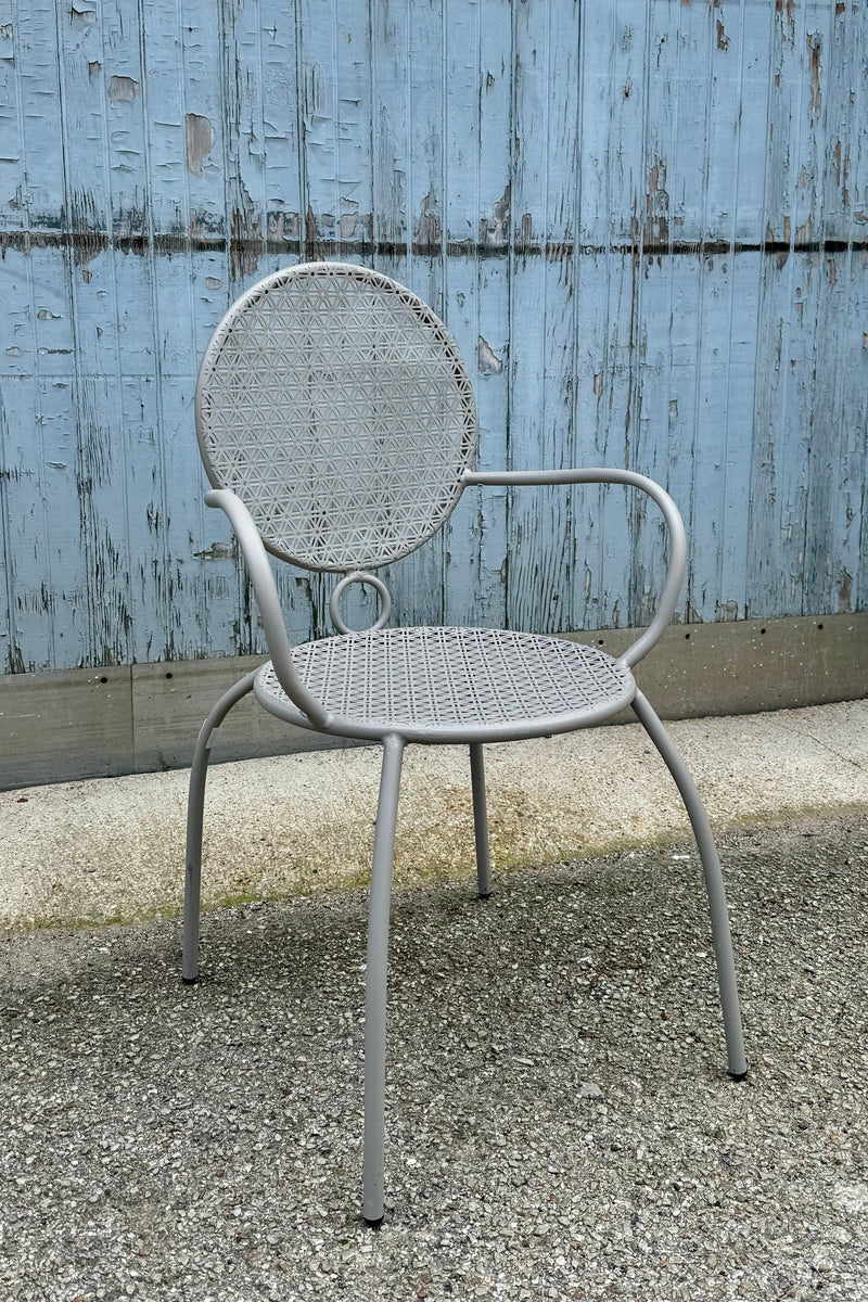 Grey bistro chair at Sprout Home sitting on a concrete floor