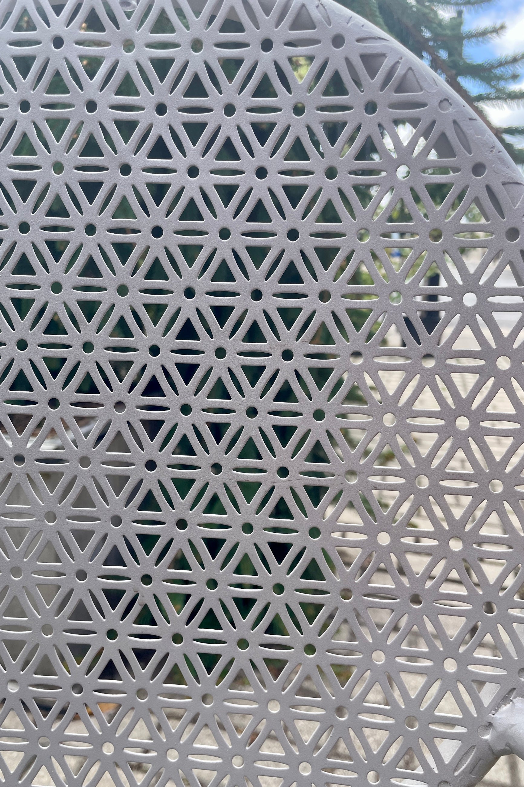 Detail of the metal work of the gray bistro chair at Sprout Home.  ©Sprout Home