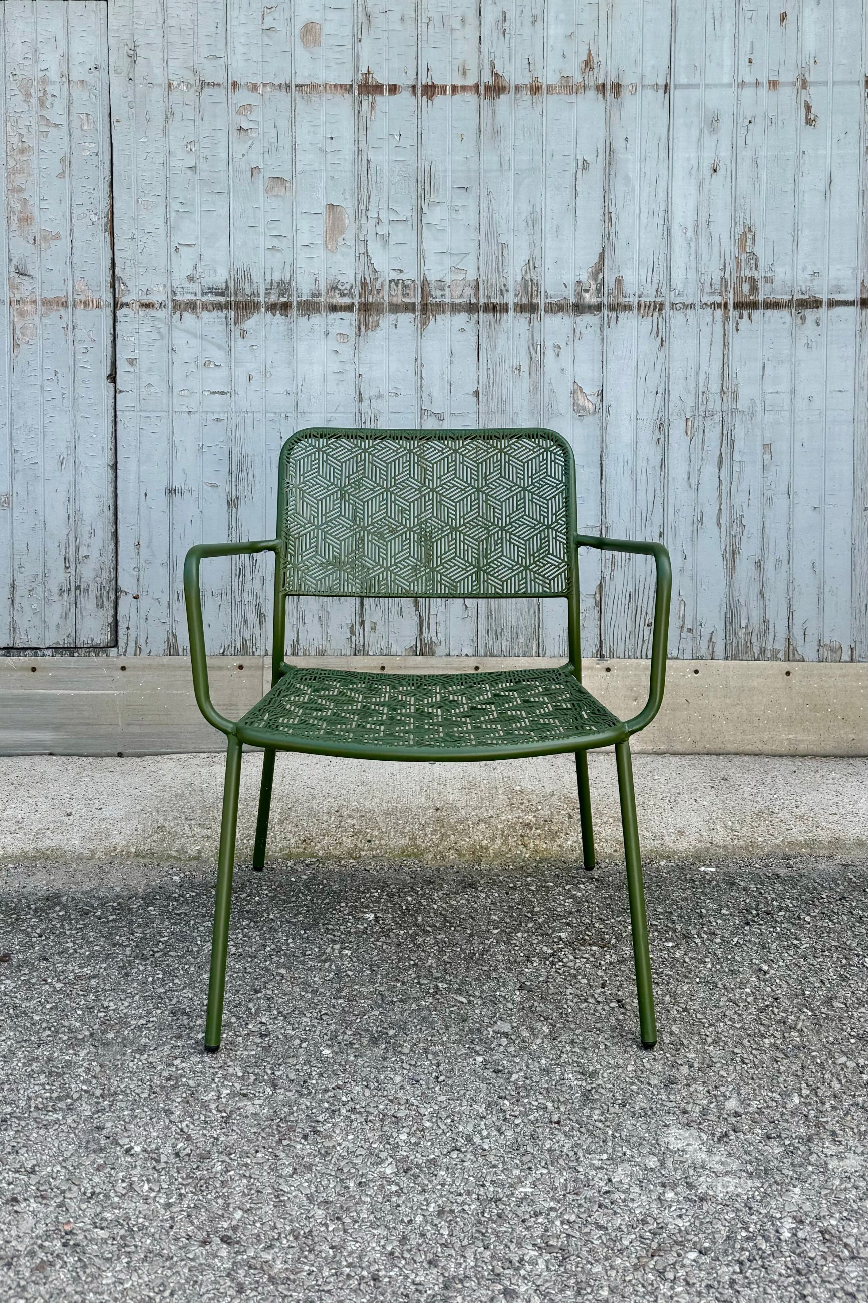 The green martini low profile chair viewed from the front at eye level.   ©Sprout Home