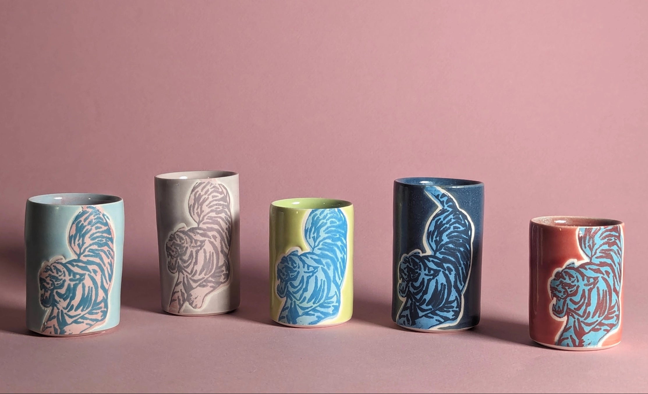 Set of six ceramic cups with animal patterns on a pink background ©City in Bloom Ceramics