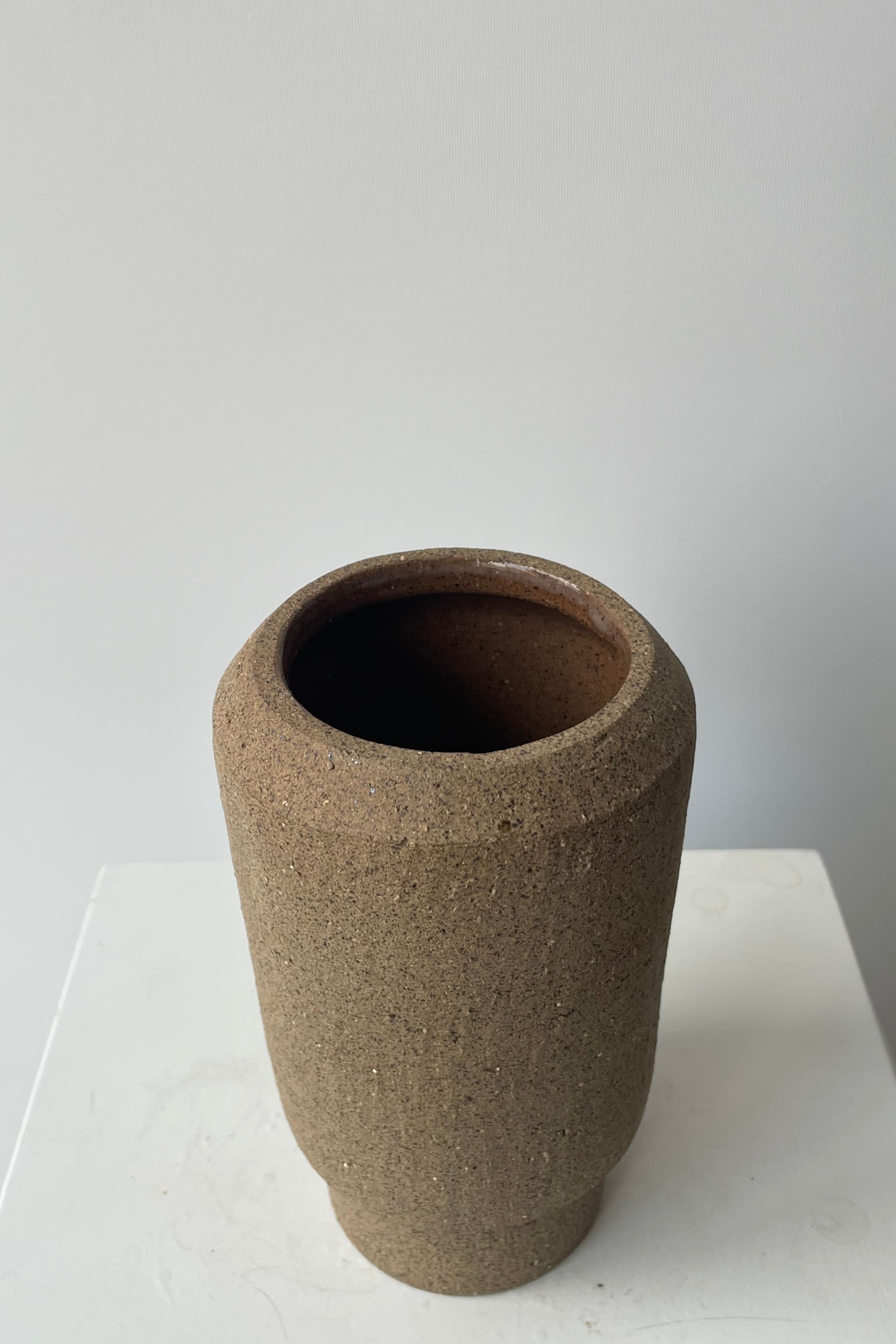 Photo looking down of top and interior of Valdez vase against a white wall.