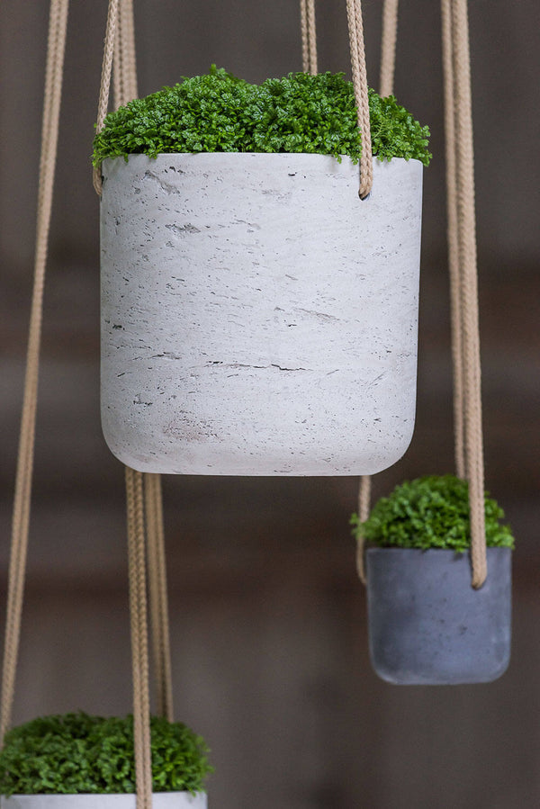 Pottery Pots Charlie hanging planters with a medium hanging gray one in front with a moss plant inside.