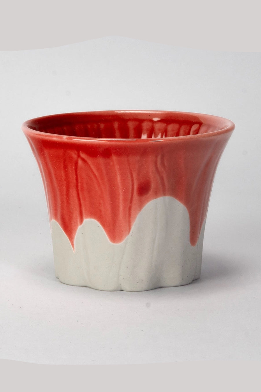Ceramic Sakura Fuji cup with red top and white bottom on a light gray background ©Urban Tokyo