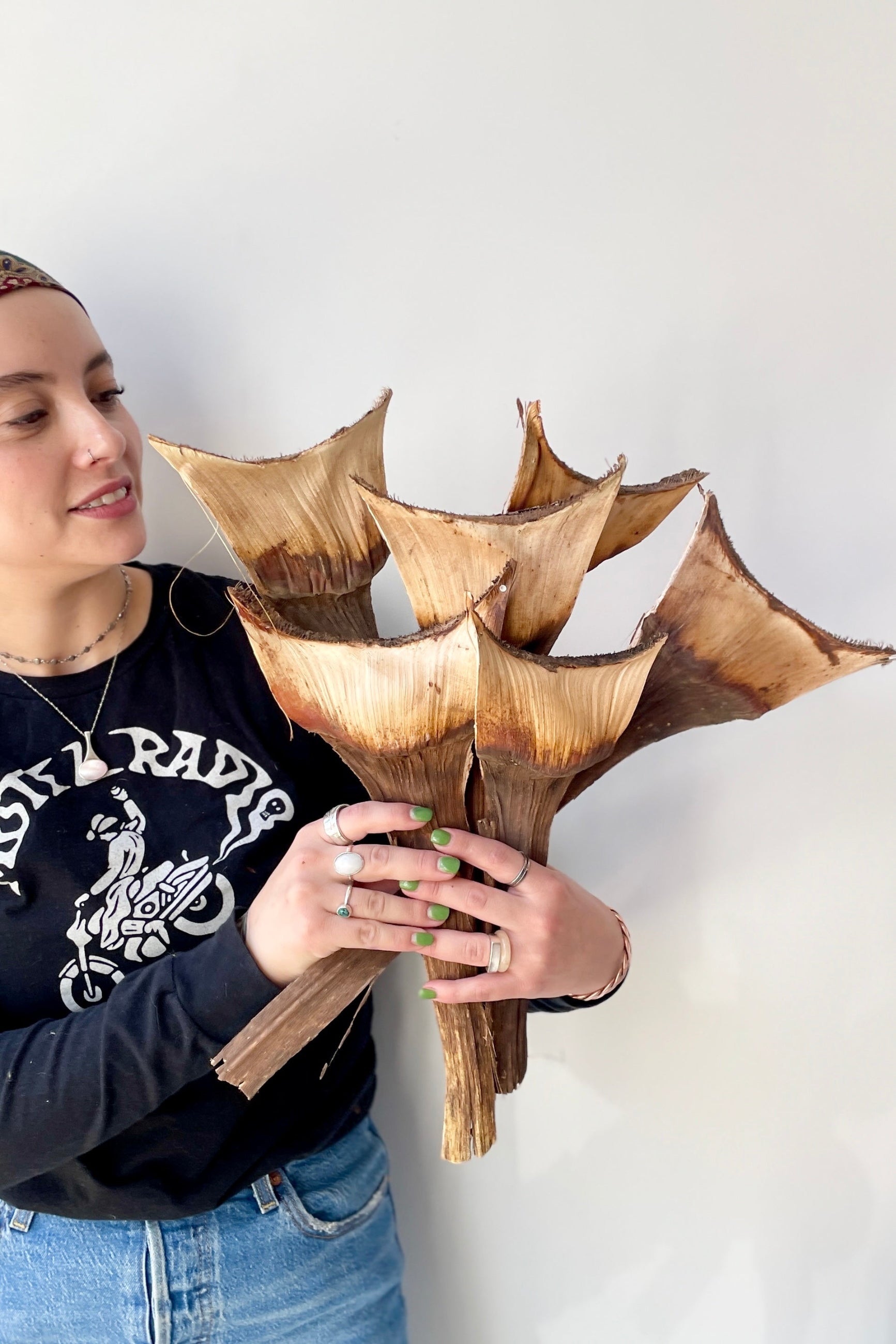 Agave Medio branches preserved at SPROUT HOME being held by a Sprout Home staff member. 