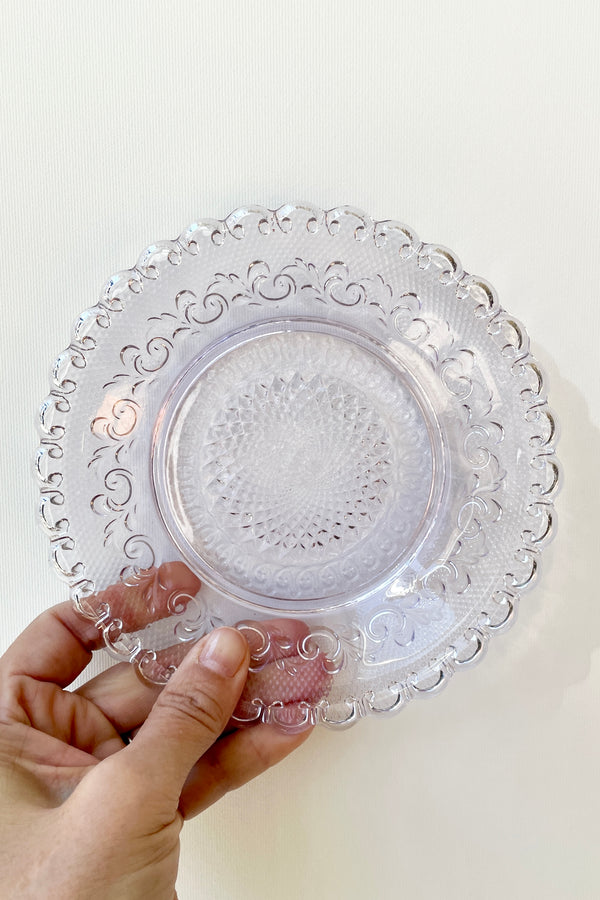 Dentelle Amethyst Chantilly Glass Plate being held against a white background