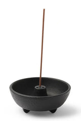 Black weight incense burner holder with an incense  stick in it. 