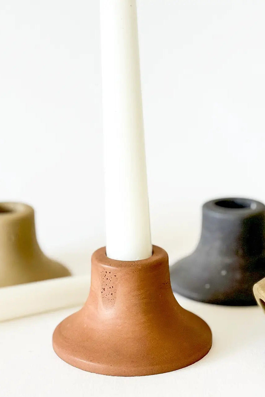 Set of ceramic candle holders in various colors on a white background ©Sunday Nomad