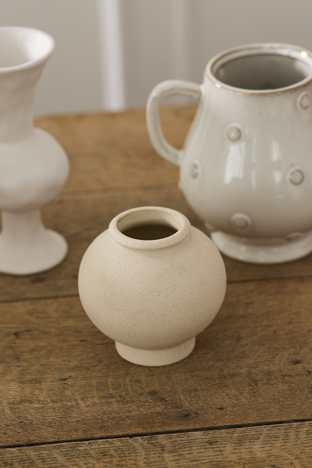 Three ceramic vases on a wooden surface with a neutral background ©Accent Decor