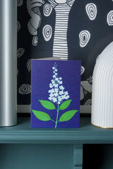 Wisley Hydrangea card by Stengun Drawings on a teal ledge sitting in front of a black and white print.