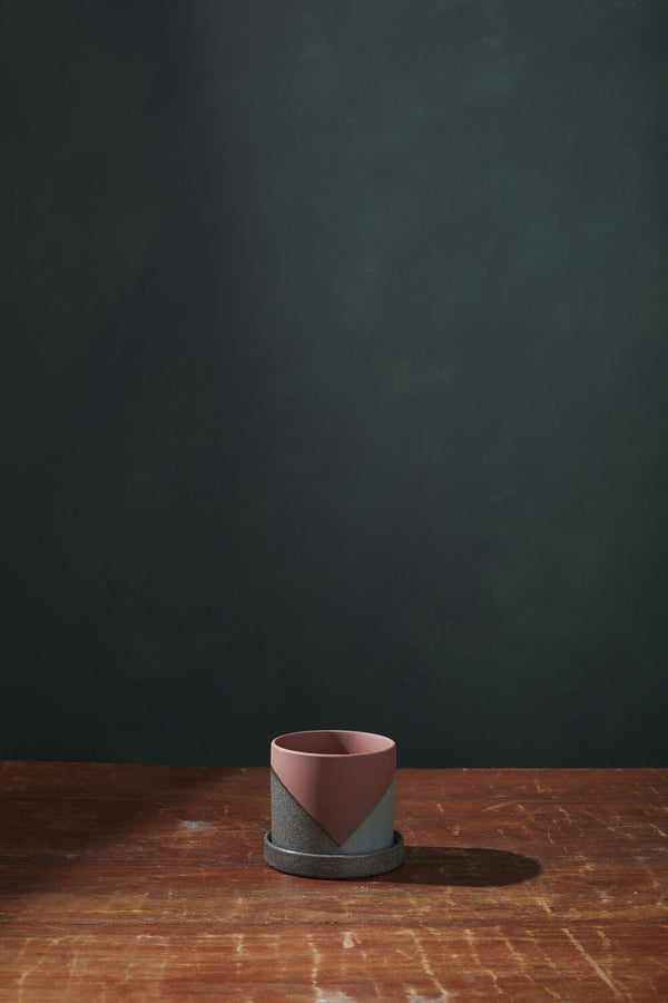 An empty El Cerro pot on a wood table and dark gray background. 