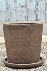 The medium size Maracay Carob colored planter in medium shown from the side with its etching. 