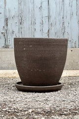 Large Lara Carob Planter shown from the side at eye level with its horizontal etching. 