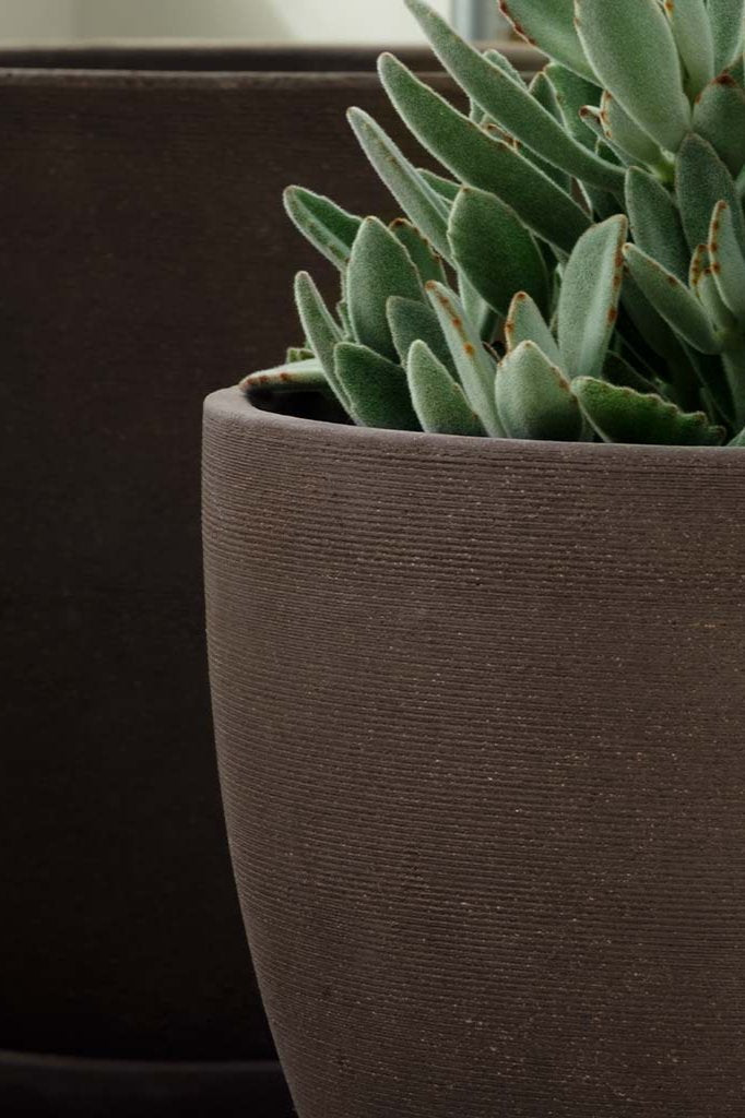 A detailed view of the horizontal texture of the Carob Lara Planter. 