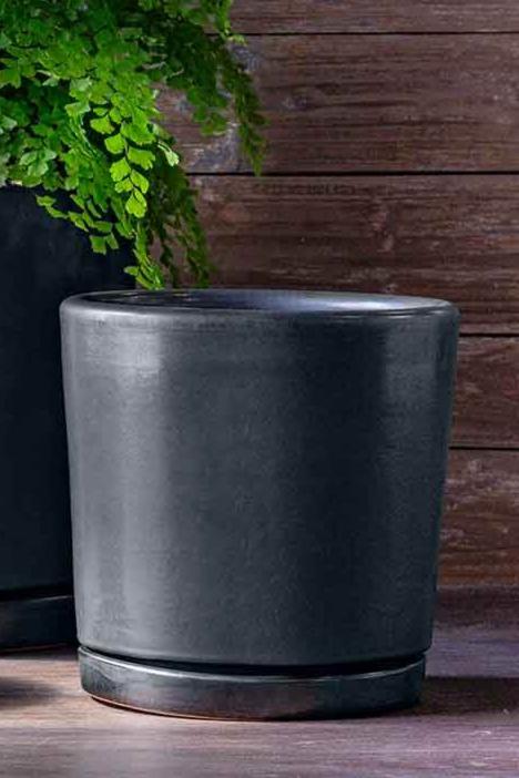 Medium Graphite glazed I/O 2 cylinder planter empty and against a wood slatted wall